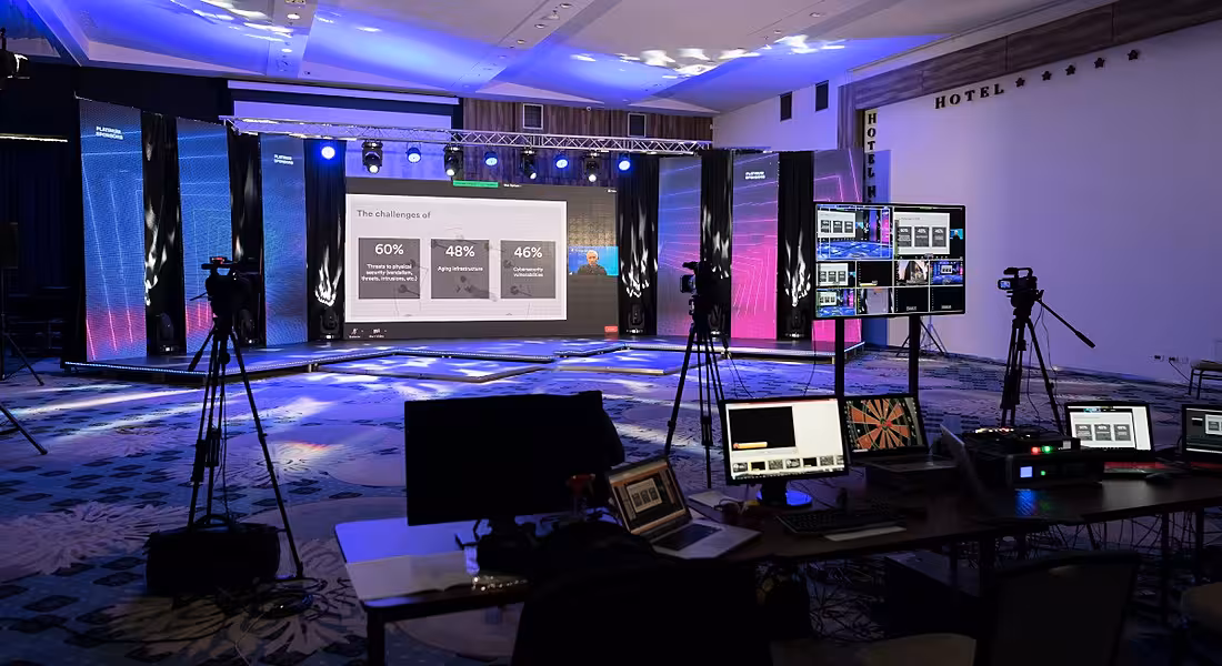 Virtual event set-up tech in an empty TV studio room.