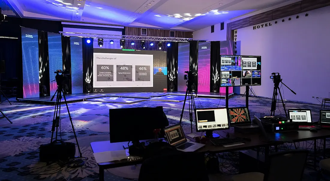 Virtual event set-up tech in an empty TV studio room.