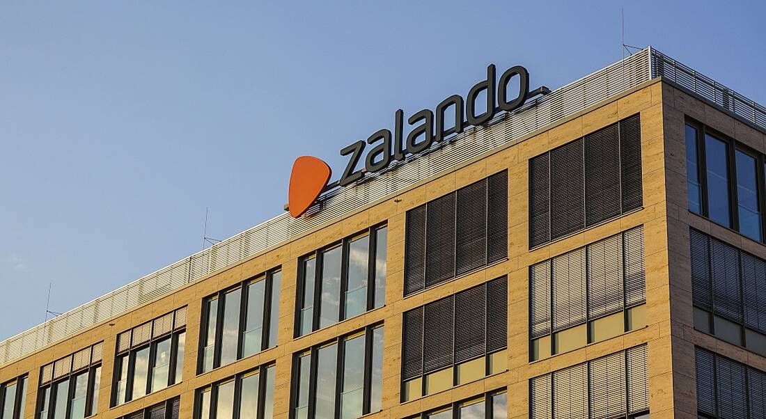 An office block against a blue sky, with the Zalando logo on top.