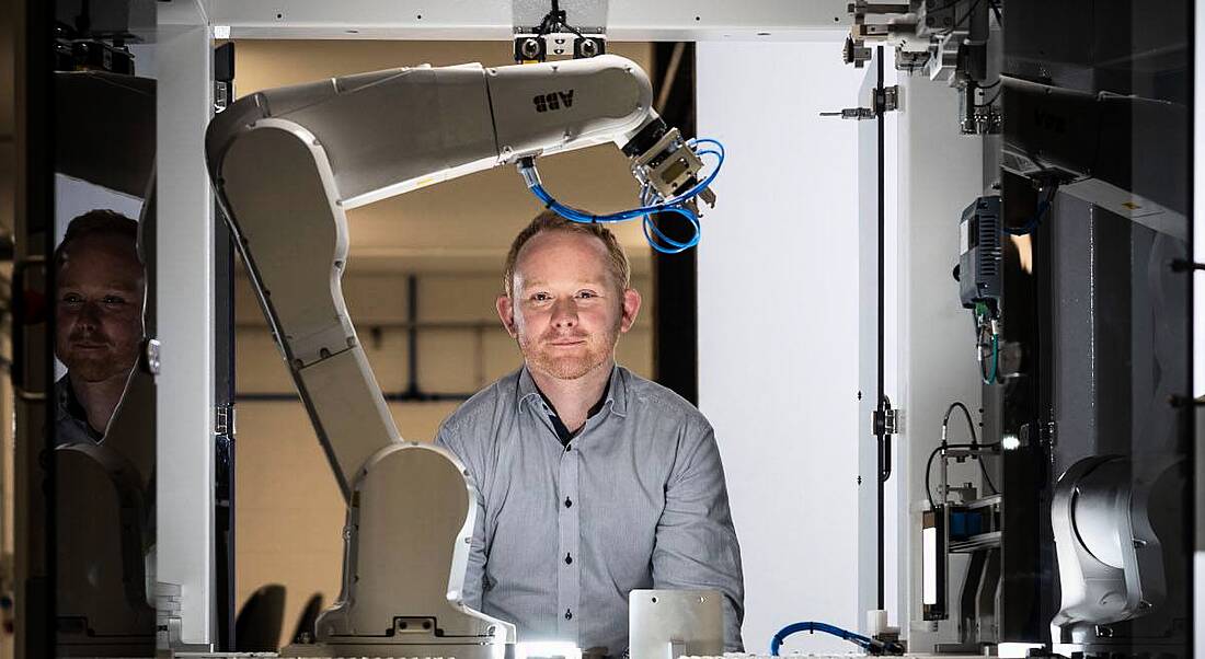 Noel Horgan in Kaon's Cork manufacturing facility surrounded by robotics arms and machines.