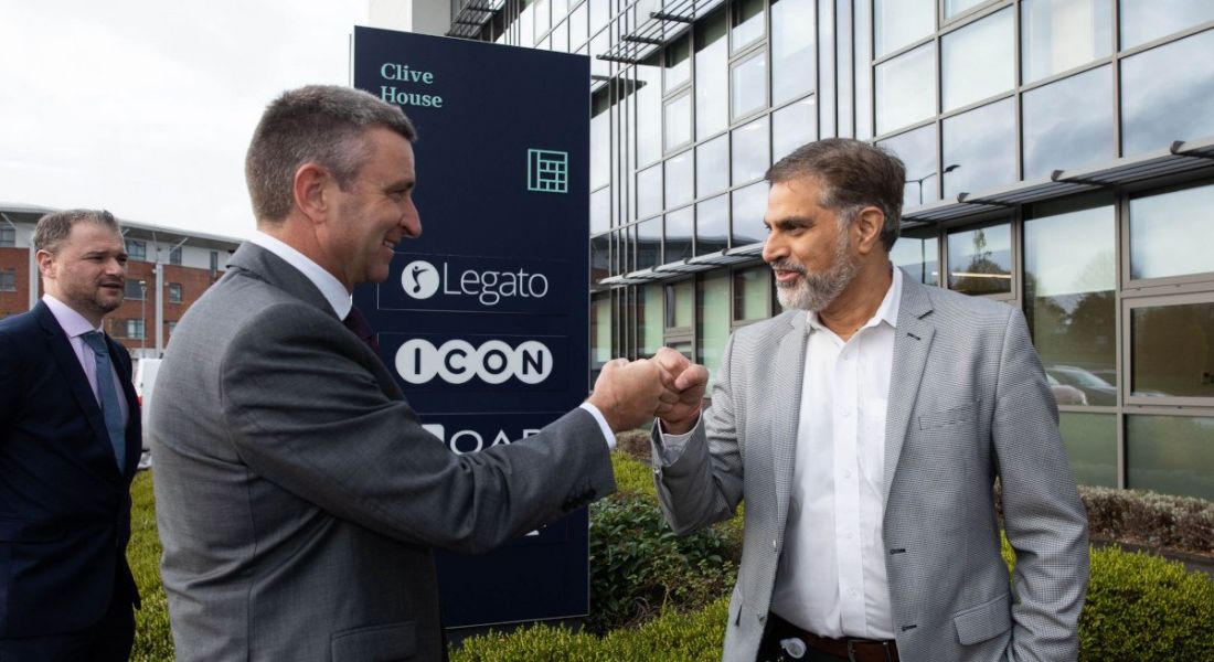 Minister Niall Collins, TD fist bumping Legato president Rajat Puri outside the company's new Limerick R&D hub.