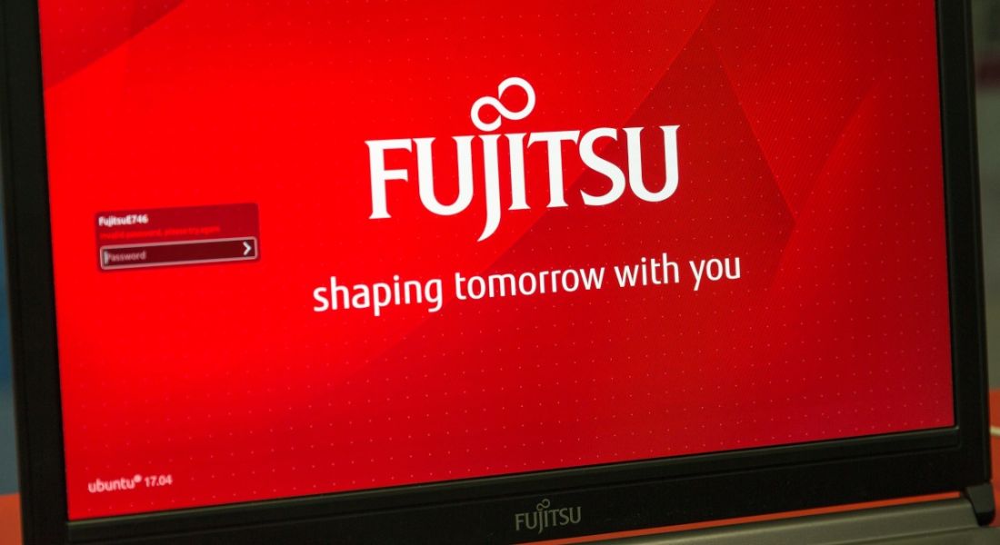 Fujitsu logo displayed on red background on a laptop screen.