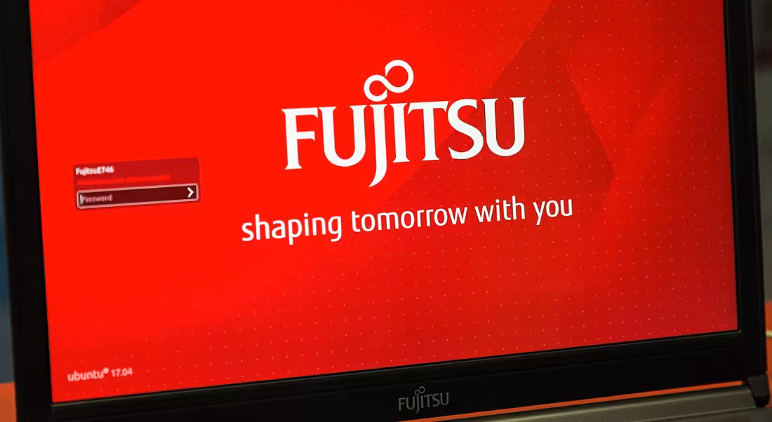 Fujitsu logo displayed on red background on a laptop screen.