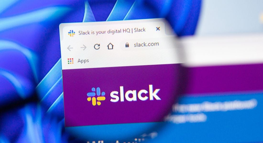 Magnifying glass focused on an open browser tab showing Slack productivity software.