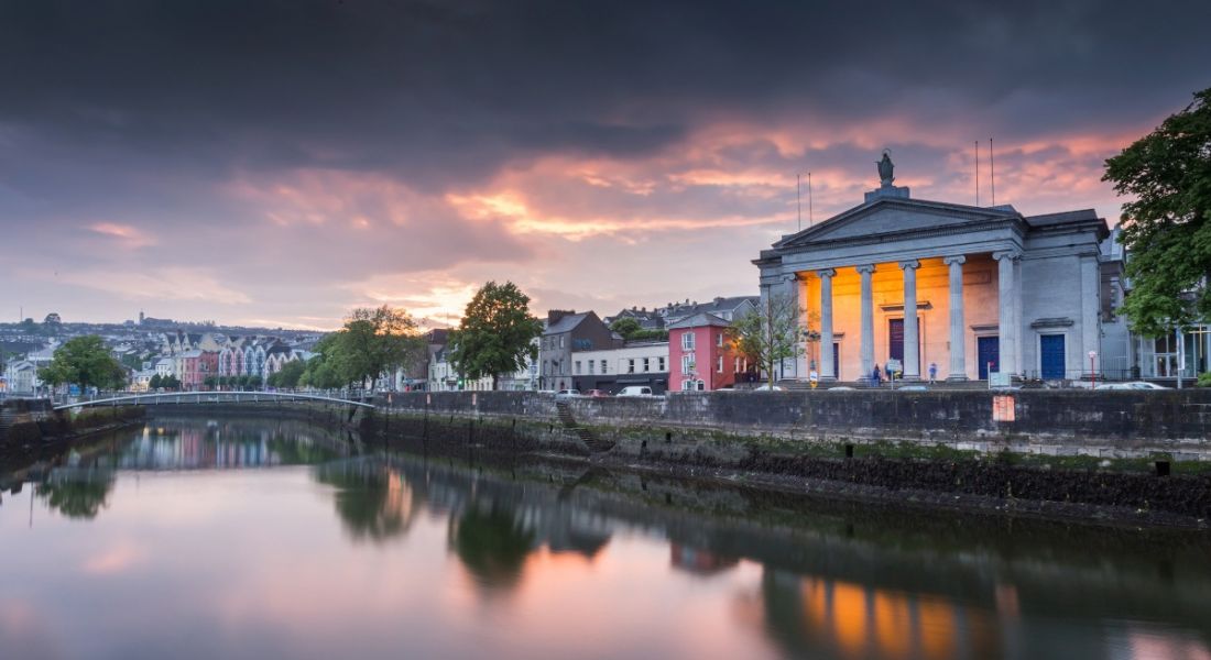 A sunset shot of Cork City with the river in the foreground.