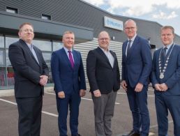 Taoiseach Micheál Martin and Niamh Hanney stand in front of a piece of Boston Scientific equipment at the company's base in Galway.