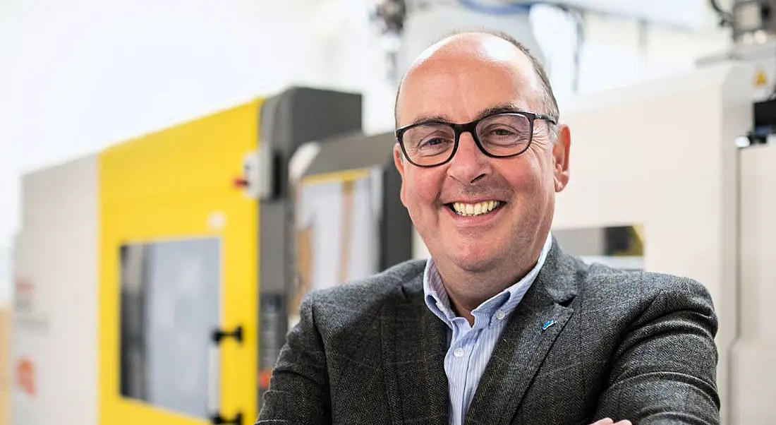 Head and shoulders shot of Frank Keane CEO of Vitalograph standing outside with a yellow and grey building in the background.