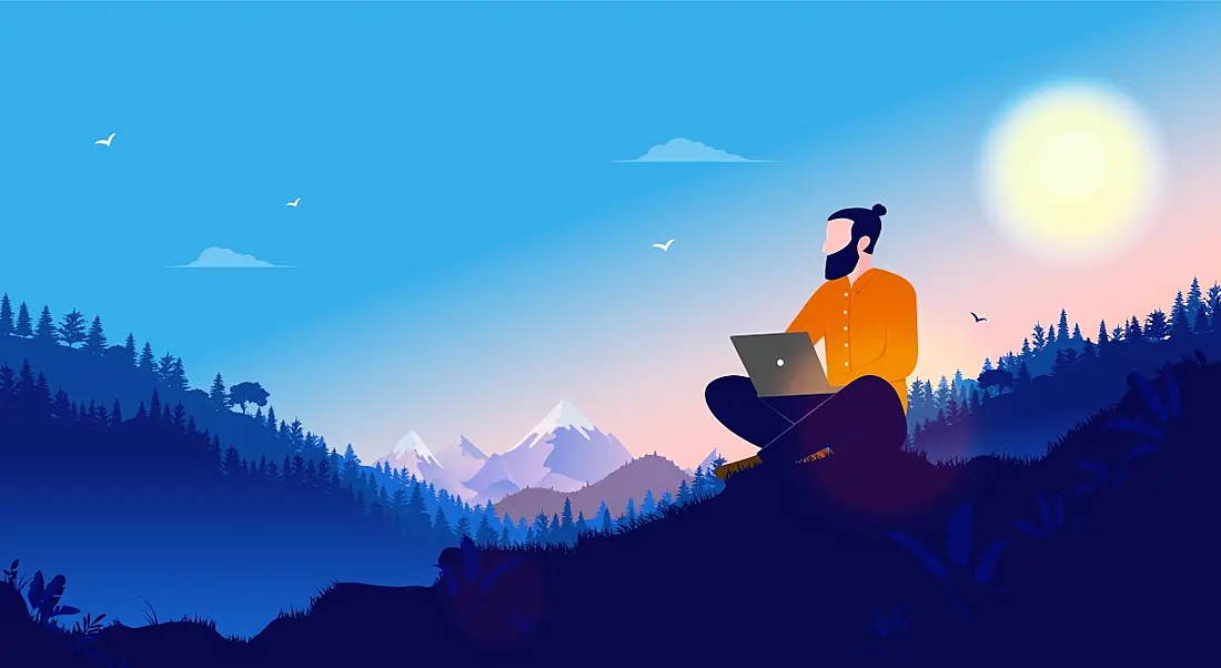 A cartoon of a man, working at his laptop while sitting on a remote mountainside.