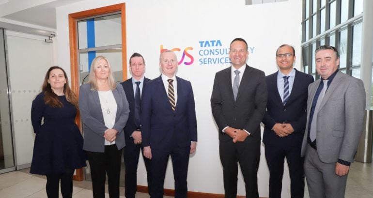 Seven people standing in a row at TCS in Letterkenny Donegal offices.