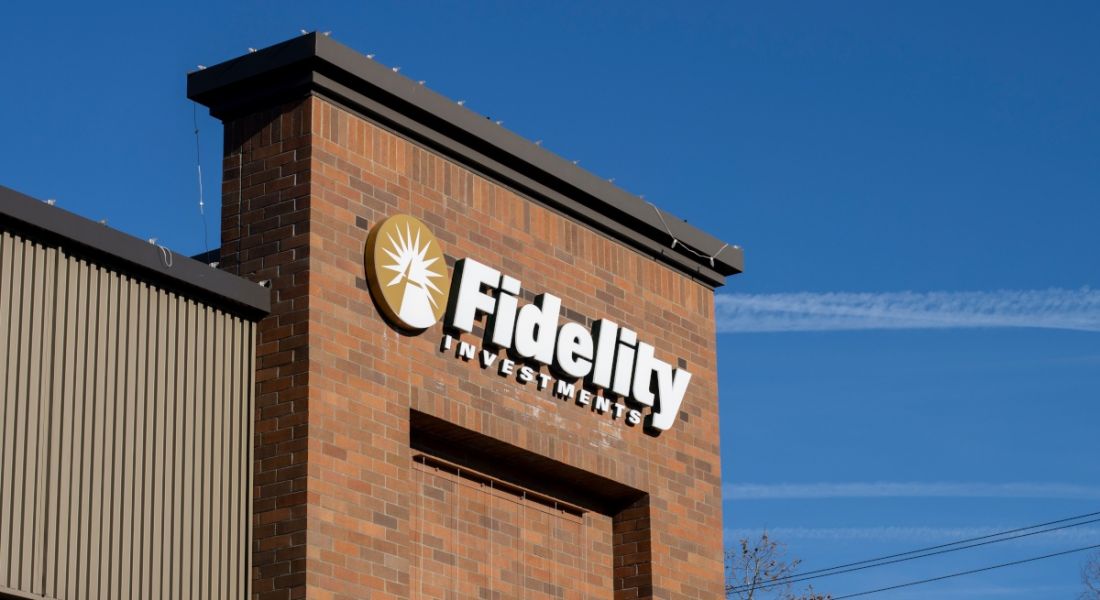 Fidelity Investments logo on a brick-designed building with a blue sky in the background.