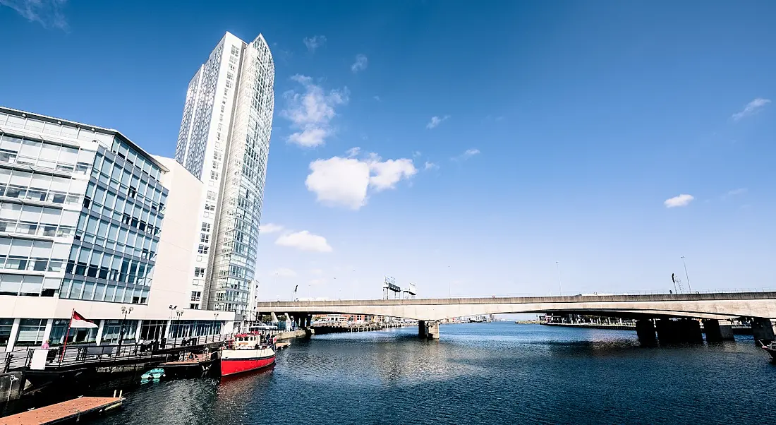 Belfast skyline with bridge and buildings on the edge of the river.