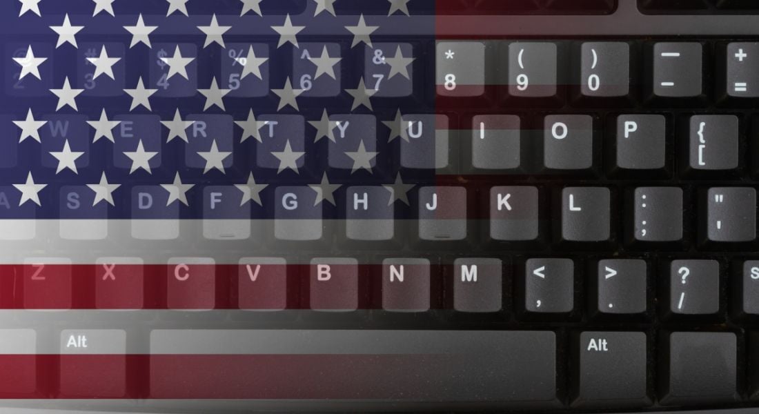 A black desktop keyboard with the US flag superimposed onto it.