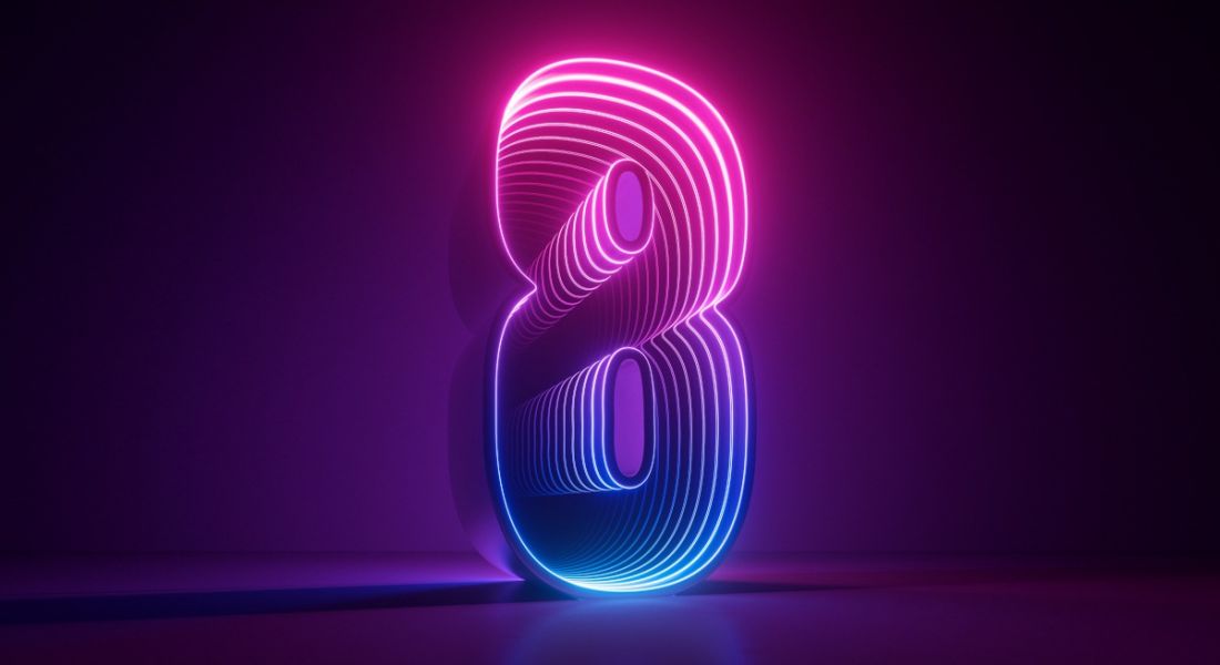 The number eight lit up in pink and purple and blue shades against a dark purple backdrop.