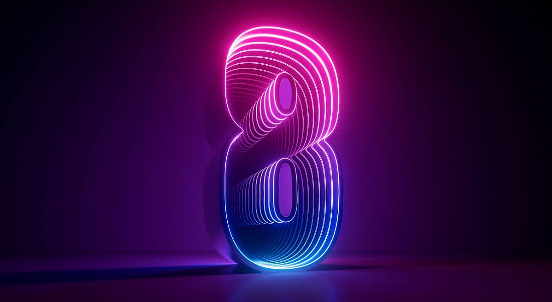 The number eight lit up in pink and purple and blue shades against a dark purple backdrop.