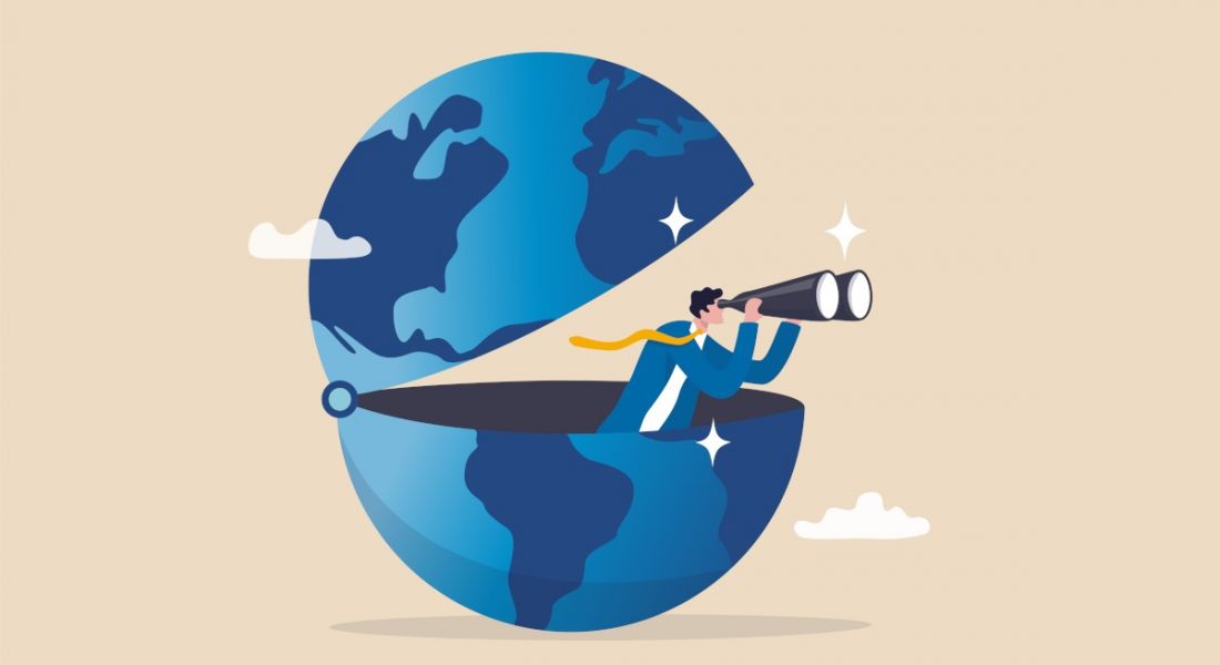 Illustration of a globe of the Earth that is open in the centre, with a man peering out with a pair of binoculars. The image is meant to illustrate international jobseekers.