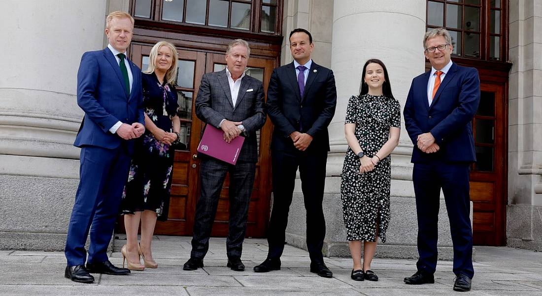 A group of people stand outside Government buildings in Dublin.