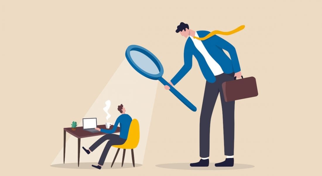 Illustration of a large man using a magnifying glass to look down on a smaller man at a desk, symbolising micromanagement.