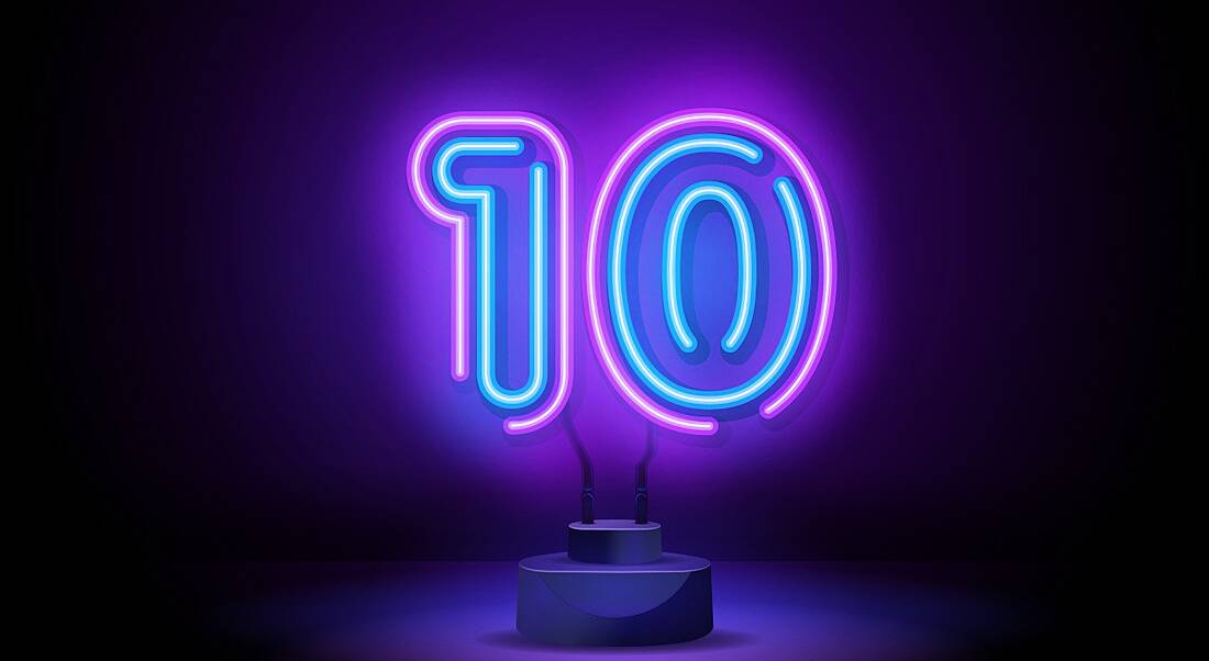 Neon blue and pink LED light shaped like a number 10 on a dark background.