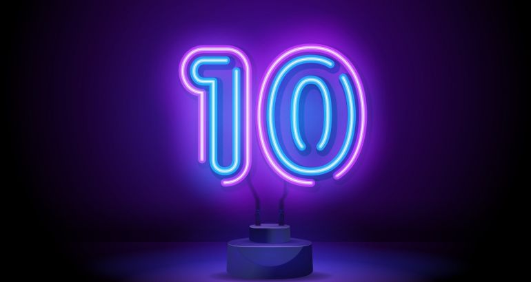 Neon blue and pink LED light shaped like a number 10 on a dark background.
