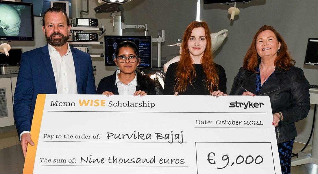 Purvika Bajaj receiving a cheque for her AI scholarship from Stryker which will be based in MTU. There are three other people in the image standing beside her.