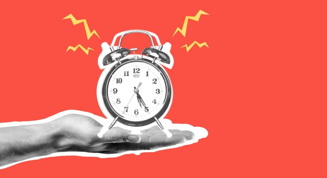 A graphic image of a hand holding out an alarm clock that is ringing.