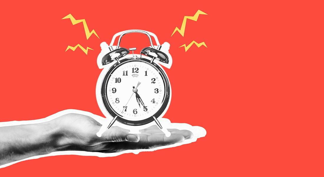 A graphic image of a hand holding out an alarm clock that is ringing.