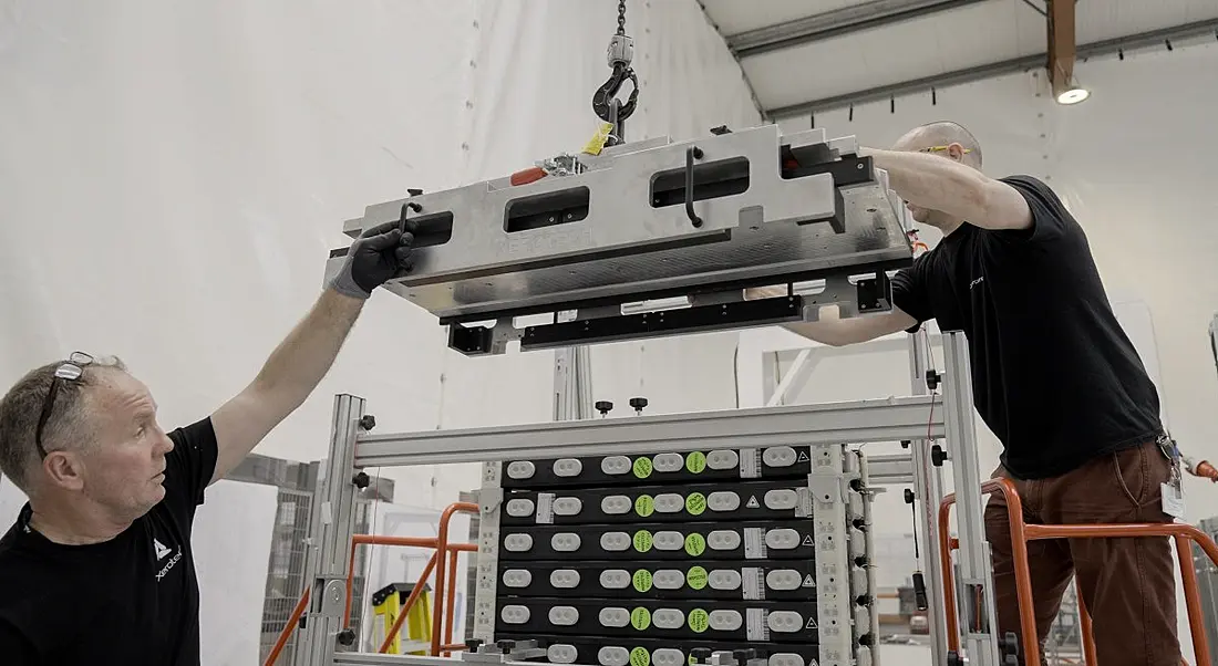 Two men working on a battery manufacturing project with machinery at Xerotech.