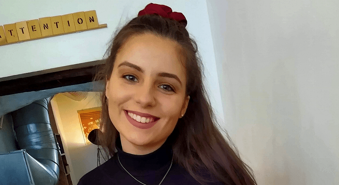 A headshot of a young woman smiling at the camera.