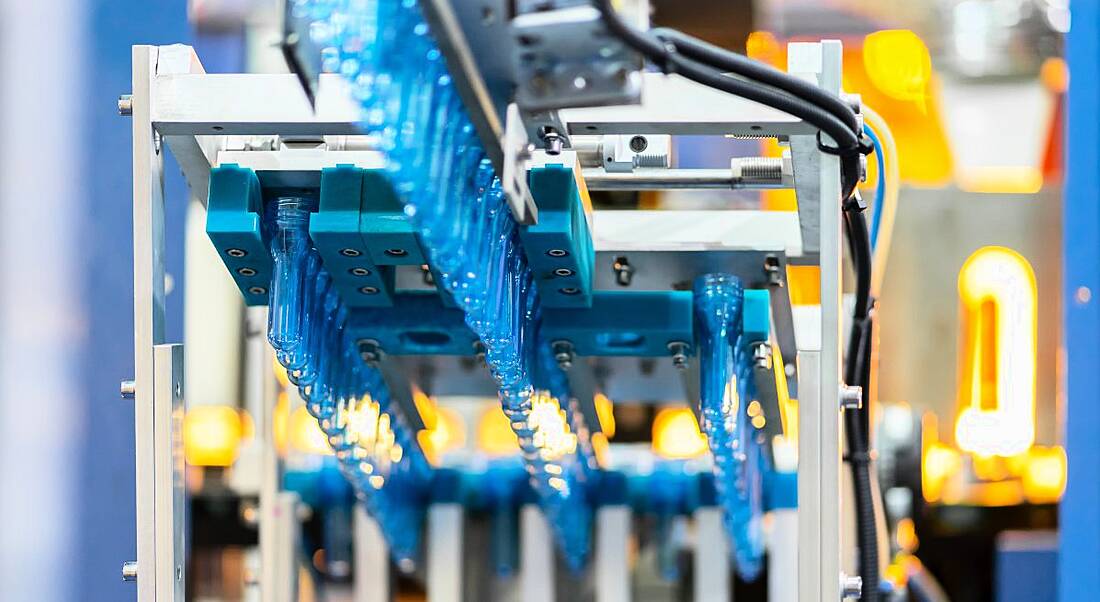 Manufacturing assembly line with plastic bottles and tubes.