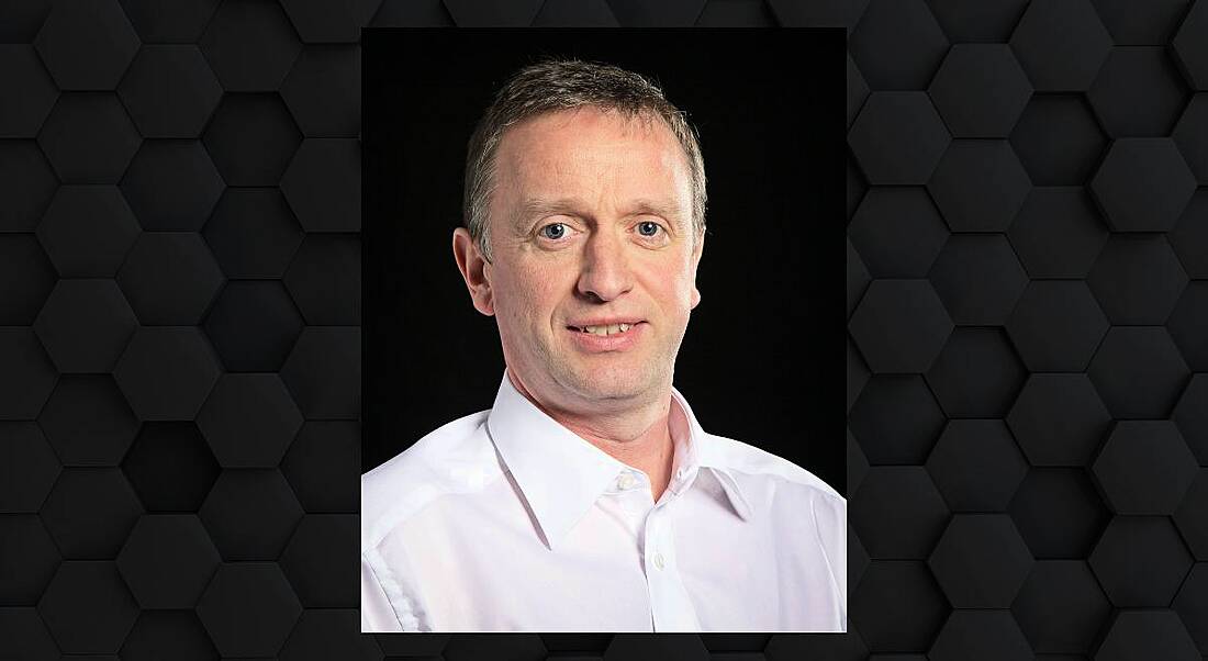 A headshot of Ger Madden against a black background.