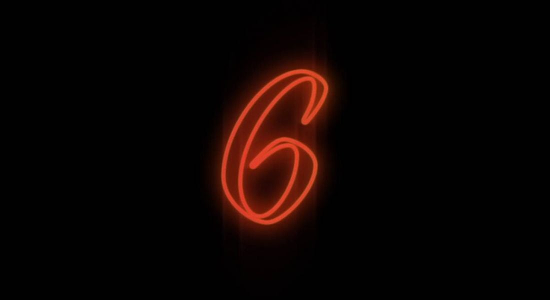 The number six appearing in neon lights against a black background.