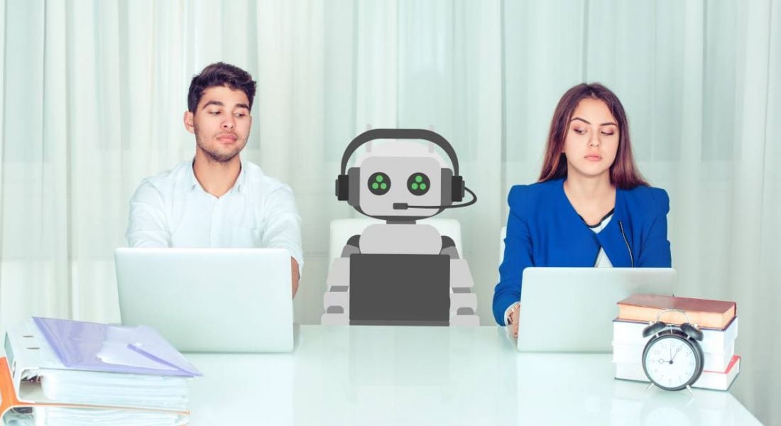 Man and woman at work in an office with an AI robot sitting between them and a clock and book binders on the desk.