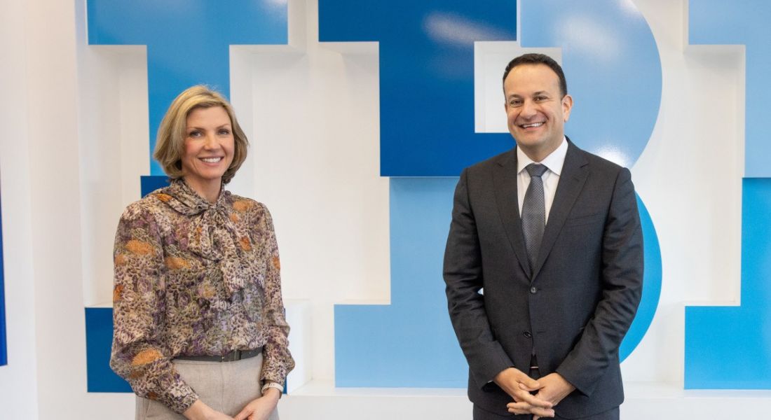 IBM's Deborah Threadgold and Leo Varadkar stand in front of a wall with the IBM logo in the background.