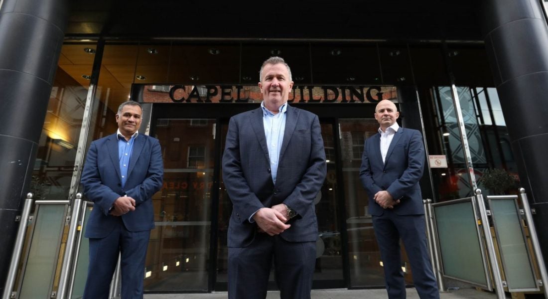 Three men from CubeMatch standing outside its new office in Dublin's Capel Buildings.