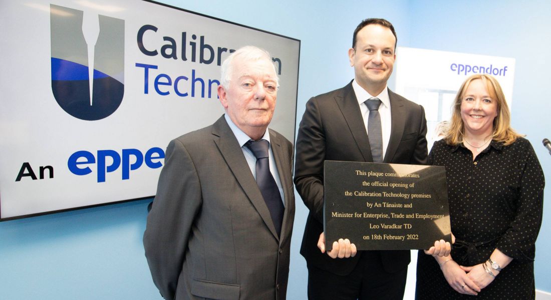 Leo Varadkar stands with a man and a woman in front of a sign that says Calibration Technology.