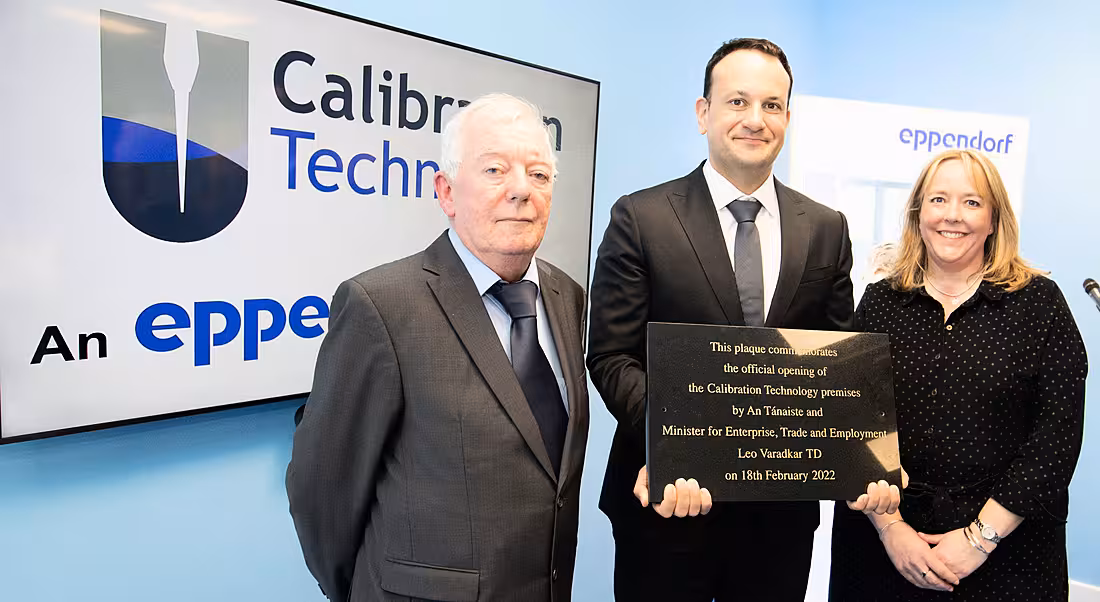 Leo Varadkar stands with a man and a woman in front of a sign that says Calibration Technology.