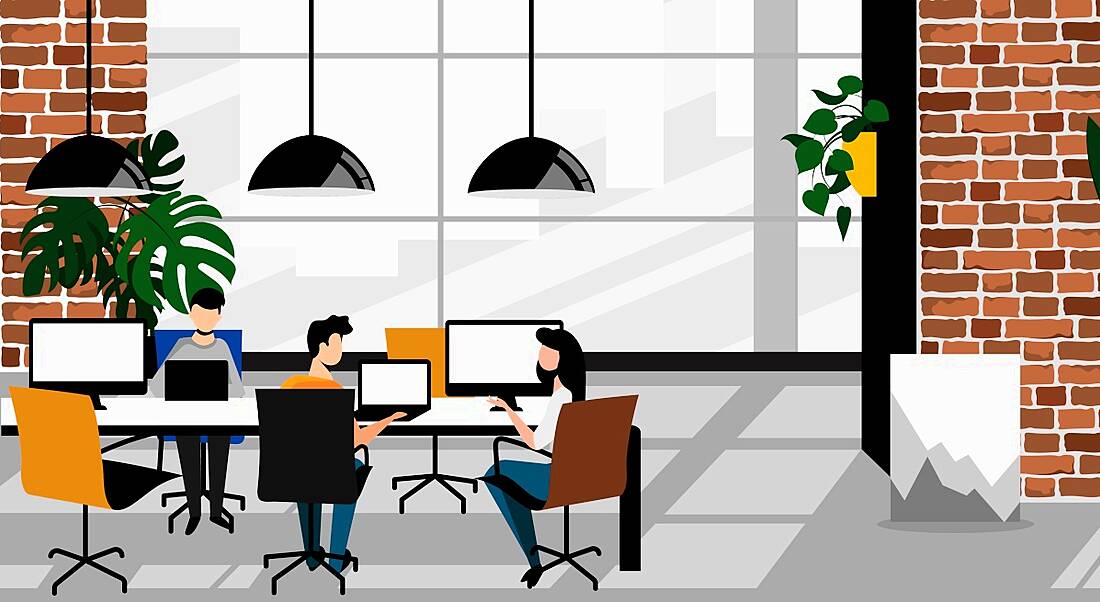 Cartoon featuring three people working at a communal desk in a co-working hub with bright, modern interiors.