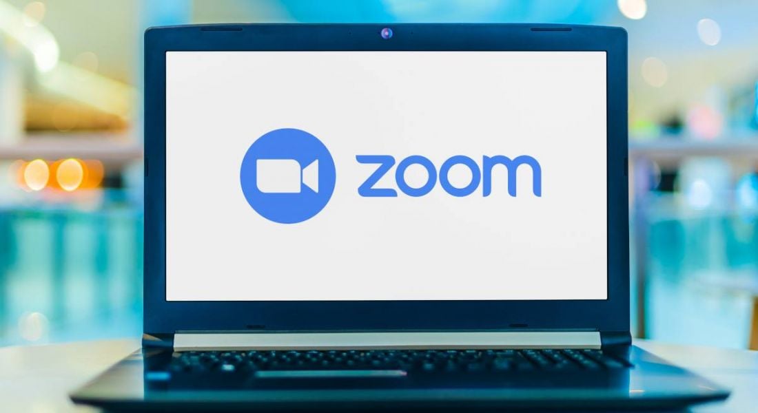 Laptop open with the screen displaying the Zoom logo and letters.