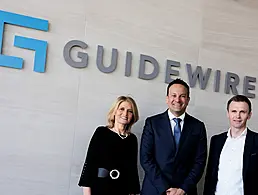 John O'Sullivan, Martin Corkery and Caroline Horgan stand outside an office that says 'Zevas' on the wall.