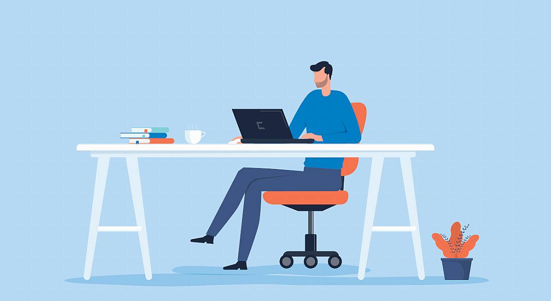 A cartoon image of a man sitting at a desk working from home, symbolising the remote working bill.