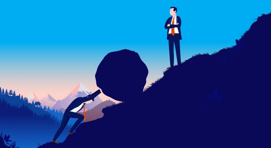 A cartoon image of a man in a suit pushing a boulder up a hill while another man stands higher up the hill staring at him. Representing a struggling employee.