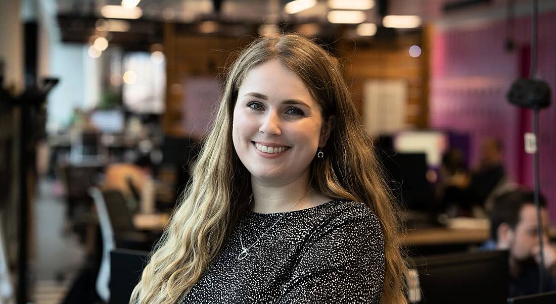 A headshot of Megan Lunney from Accenture sitting in an office space.