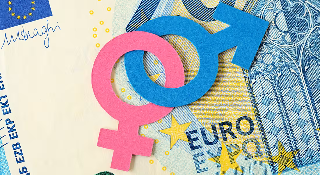 Gender symbols in pink and blue lying on a 20 euro note.