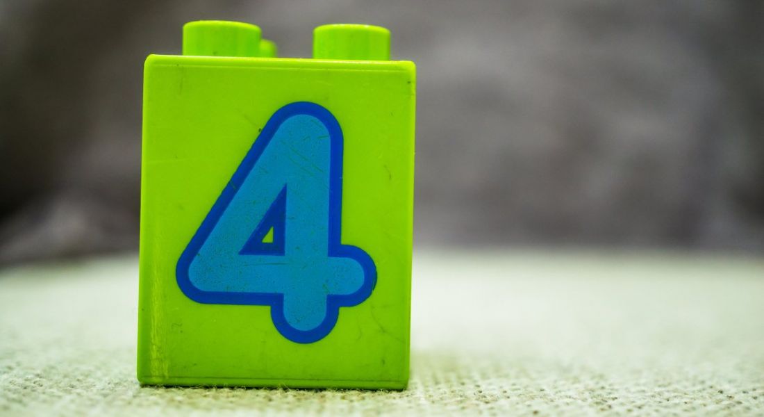 Green building block toy with the number four on it in blue.