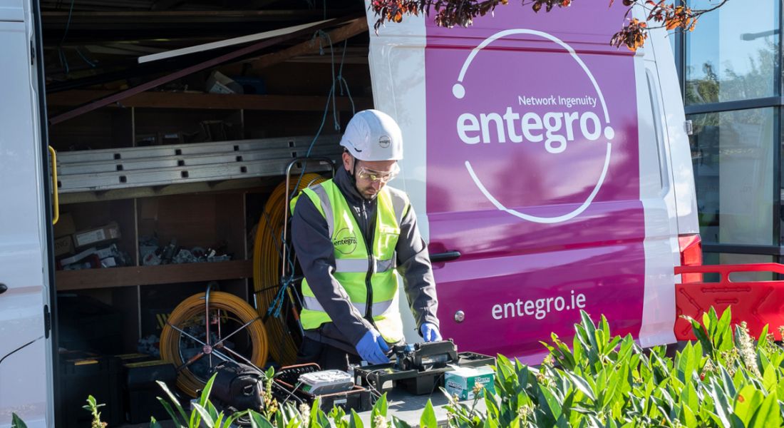A man working out of a van with the Entegro logo on it.