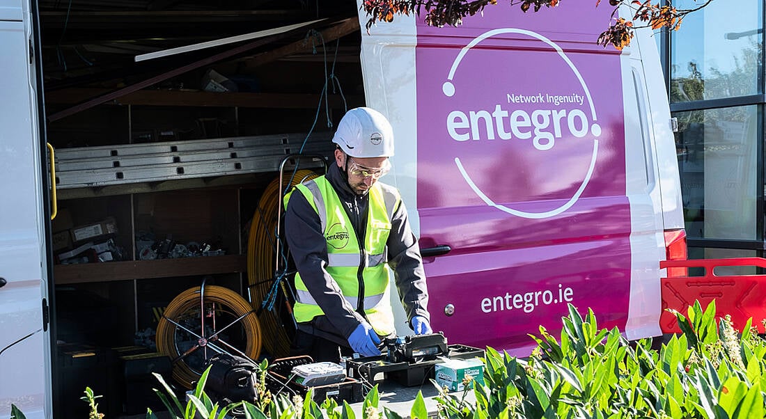 A man working out of a van with the Entegro logo on it.