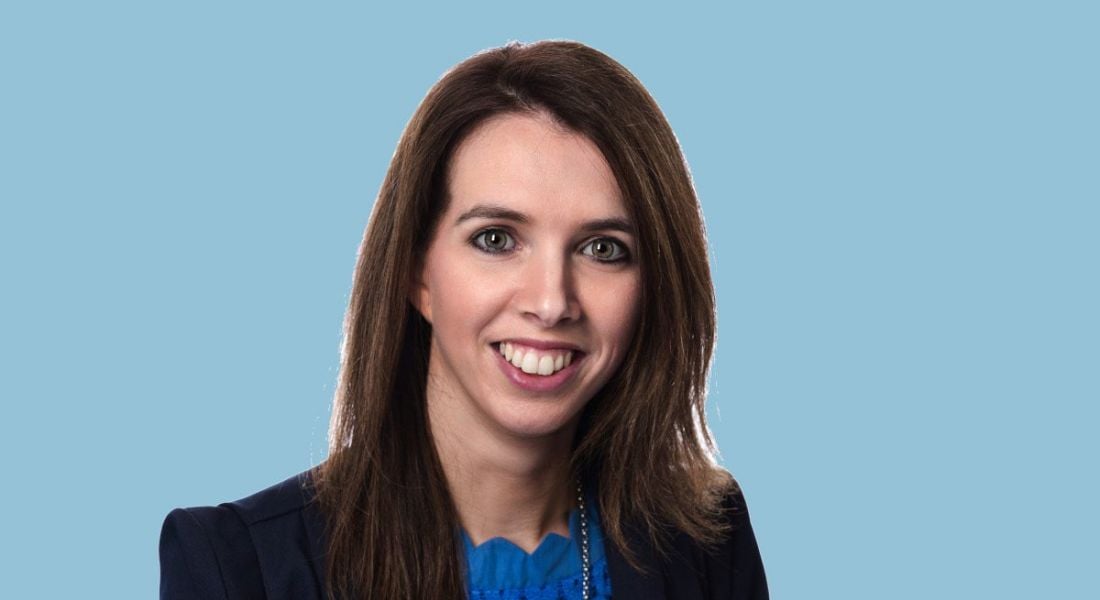 Headshot of Terri O'Donovan on a soft blue background.