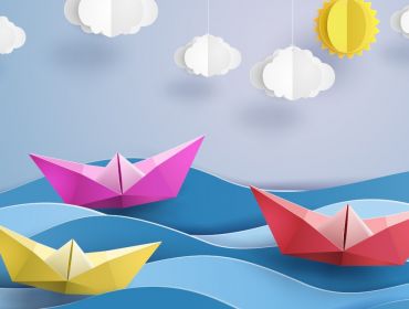 A graphic of origami paper boats floating on the sea.