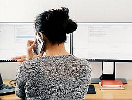 Businesswoman speaking on video call with diverse colleagues on her laptop from home.