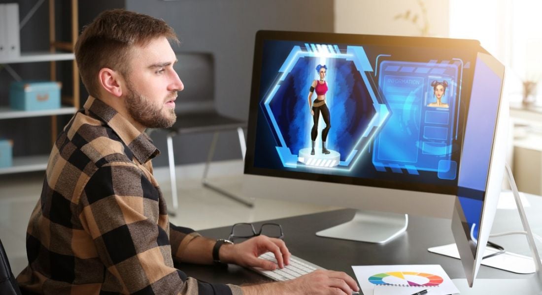 Man working as an animator with two computers in front of him.